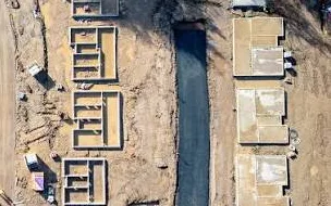 Full-resolution detail from the same orthomosaic, zoomed to individual stem-wall footings, formwork panels and a utility trench, showing the pixel detail a georeferenced raster tile carries.